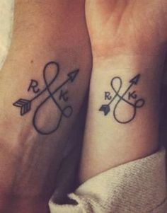 two people with matching tattoos on their wrists, one has an arrow and the other has