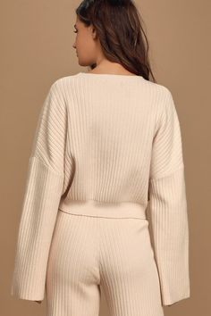 The Lulus Snuggly Style Cream Ribbed Knit Cropped Sweater is on the top of our must-have list! Cozy ribbed knit makes up this cute sweater with a rounded neckline, drop shoulders, and long wide sleeves that offer that perfect slouchy look. Relaxed-fit bodice ends in a cropped hem, perfect to wear with high-waisted bottoms. Pair with the matching pants for a complete look! Fit: This garment fits true to size. Length: Size medium measures 18.5" from shoulder to hem. Bust: Great for any cup size. Waist: Loosely Fitted. Undergarments: May be worn with any standard bra. Fabric: Fabric is very stretchy. Unlined. 55% Viscose, 28% Nylon, 17% Polyester. Hand Wash Cold. Do Not Bleach. Line Dry. Iron Low Heat. Imported. Lulus | Snuggly Style Cream Ribbed Knit Cropped Sweater | Size Small. Fall Cropped Sweater With Ribbed Neckline For Loungewear, Cozy Cable Knit Tops For Loungewear, Chic Knit Sweater With Ribbed Cuffs, Cozy Textured Knit Cropped Sweater For Loungewear, Ribbed Cropped Sweater For Fall Loungewear, Cozy Cropped Sweater For Fall Loungewear, Cream Sweater With Ribbed Neckline For Winter, Cozy Ribbed Cropped Sweater For Loungewear, Cable Knit Crew Neck Sweater For Loungewear