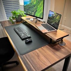 a desk with a keyboard, mouse and laptop on it