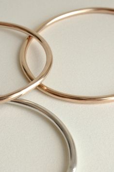 The Georgia is a timeless, minimalist bracelet style with an organic oval shape designed for constant wear. It is comfortable enough to wear even while sleeping, yet strong enough to gracefully withstand years of daily use. Each hand-soldered bracelet is shaped to mimic the contours of your forearm. Available in durable 14k gold fill, solid sterling silver, and solid 14k gold. These materials are water resistant and low maintenance. For more information, visit our Metals Encyclopedia. ✦ SIZING ( Elegant Everyday Bracelets With Round Band, Elegant Everyday Round Band Bracelets, Minimalist Rounded Jewelry With Shiny Finish, Elegant Everyday Round Band Bracelet, Minimalist White Gold Oval Bracelet, Minimalist Oval Bracelets For Everyday Wear, White Gold Oval Bracelets For Everyday, Minimalist Jewelry With Polished Rounded Finish, Minimalist Jewelry With Polished Finish