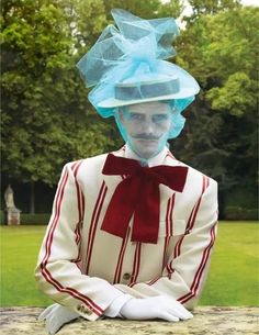 a man with blue hair wearing a white suit and red bow tie sitting on a bench