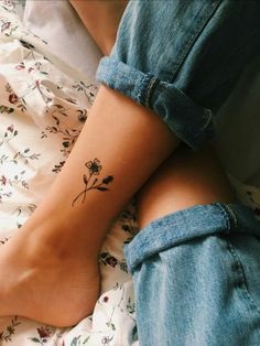 a woman's foot with a flower tattoo on it