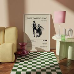 a poster on the wall next to a checkered rug in a room with two chairs