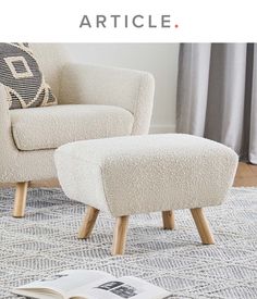 a white chair and footstool sitting on a rug in front of a window