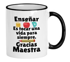 a black and white coffee mug with words in spanish on it, including an apple