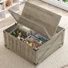 an open storage box sitting on top of a carpeted floor next to a window