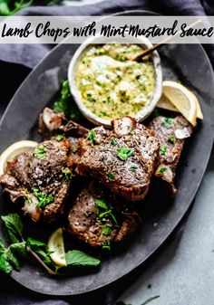 grilled lamb chops with mint - mustard sauce and lemon wedges on a plate