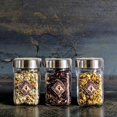 three glass jars filled with different types of food