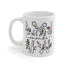 a white coffee mug with scissors and flowers on the side that says, i love canada