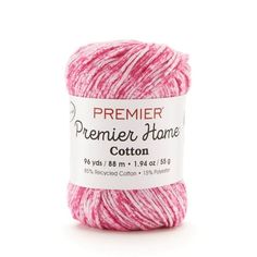 a ball of pink yarn sitting on top of a white surface with the words premier home written