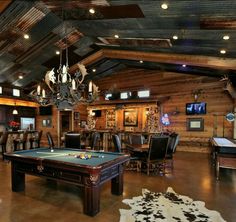 a pool table and some chairs in a room