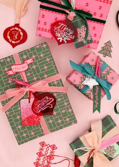 several christmas cards are laid out on a pink surface with scissors and other crafting supplies