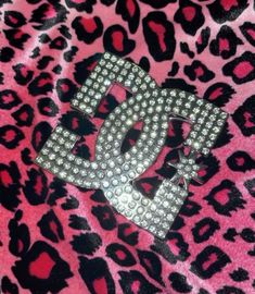 a pink and black leopard print jacket with the letter d on it