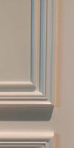 the corner of a white door with blue trim