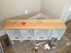 a wooden bench sitting on top of a hard wood floor