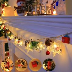 christmas decorations are hanging on the mantle