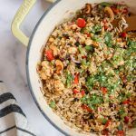 a pot filled with rice and vegetables on top of a table