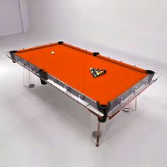 an orange pool table with a butterfly on it's back end and legs, in front of a white background