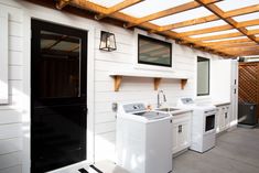 an outdoor kitchen with washer and dryer