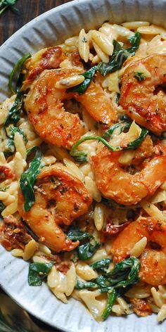 Creamy Tuscan Shrimp Orzo with Sun-Dried Tomatoes, Artichokes, and Spinach - in a white bowl. Shrimp Rositto, Creamy Tuscan Shrimp, Shrimp And Spinach, Shrimp Spinach, Tuscan Shrimp, Shrimp Orzo, Seafood Dish Recipes, Creamy Shrimp