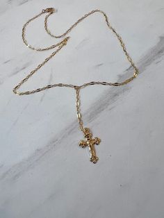 Elevate your style with our Crucifix necklace, featuring a delicate sequin chain perfect for layering. Express your faith with elegance in a subtle yet powerful way. 14K Chain is 18" long with a 2" drop Gold Cross Necklace Long, Dainty Crucifix Necklace With Adjustable Chain, Dainty Gold Chain Lariat Necklace, Gold Jewelry Cross, Dainty Lariat Necklace With Gold Chain, Dainty 14k Gold Cross Necklace With Delicate Chain, Dainty Gold Lariat Necklace, 14k Gold Filled Cross Necklace With Delicate Chain, Cross Necklace Aesthetic