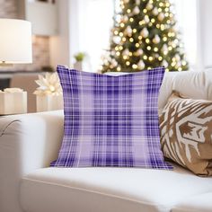 a living room filled with furniture and a christmas tree in the backgroung