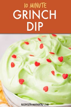 a close up of a cake with green frosting and red hearts on the top