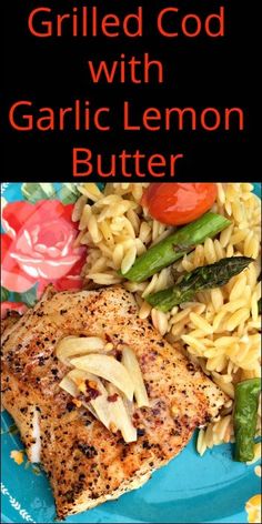 grilled chicken with garlic lemon butter on a blue plate topped with pasta and vegetables