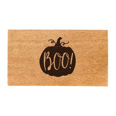 a door mat with the word boo written on it and a pumpkin in the center