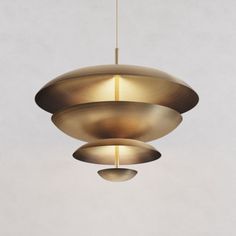 three circular lights hanging from the ceiling in a room with white walls and flooring