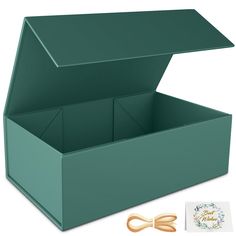 an open green box with scissors in it