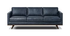 a blue leather couch sitting on top of a wooden frame