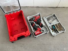 a tool box with tools in it sitting on the ground next to another case filled with tools