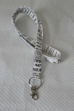 "Newsprint Lanyard / Black and White Key chain / Key Lanyard / ID Badge Holder / Fabric Lanyard / Teacher Lanyard / Pretty Lanyards / Lanyard and ID Holder / Nurse Lanyard This lanyard is made from newspaper print fabric in the colors of black and white. The news print lanyard comes with 2 attachment options - a swivel clasp which can easily attach to a plastic badge holder and a O-ring to attach to keys (shown in photos). The lanyard hangs 20 inches long from the neck (40 inches all the way aro School Lanyard, Chains Aesthetic, Nurse Lanyard, Lanyard Id Holder, Lanyard Teacher, Cute Lanyards, Black Lanyard, Aesthetic Rings, Keychain Lanyard