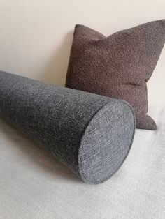 two pillows sitting next to each other on a bed