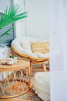 two wicker chairs sitting next to each other on top of a rug