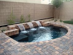 a small pool with waterfall in the middle