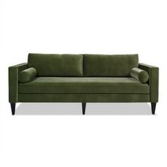 a green couch sitting on top of a white floor