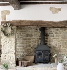 an old stone fireplace with a wood burning stove