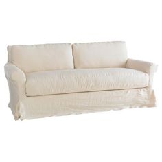 a white couch sitting on top of a wooden floor