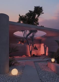 an outdoor area with rocks and plants at dusk