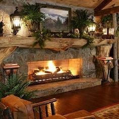 a living room filled with furniture and a fire place in the middle of a fireplace