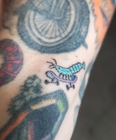 a close up of a person's arm with tattoos on it