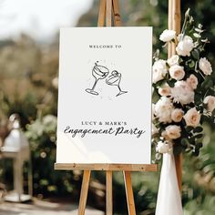 an easel with a sign that says, welcome to lucy and mark's engagement party