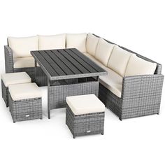 an outdoor patio furniture set with white cushions and ottomans, including a black coffee table