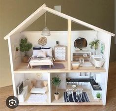 a doll house with furniture and accessories inside