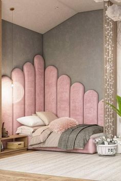 a bedroom decorated in pink and grey with a large headboard on the wall next to a potted plant