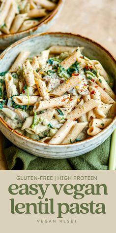 a bowl filled with pasta and spinach on top of a green napkin next to another bowl