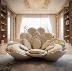 a large white sculpture sitting in the middle of a room filled with bookshelves