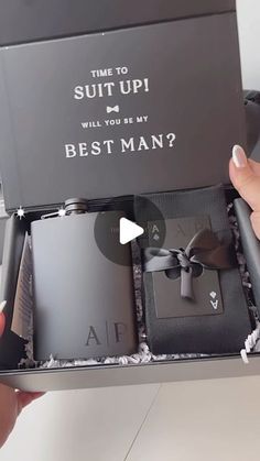 someone is holding two flasks in a box with the words, suit up will you be my best man?